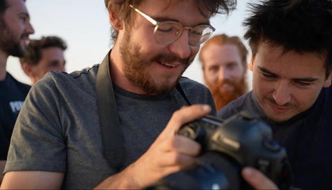 Stan and Jamie looking at their camera on Project Africa