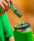 Hardest Geezer pouring a single serve matcha sachet into bottle