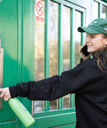 Romy wearing Perfect Ted Green Hat opening green door