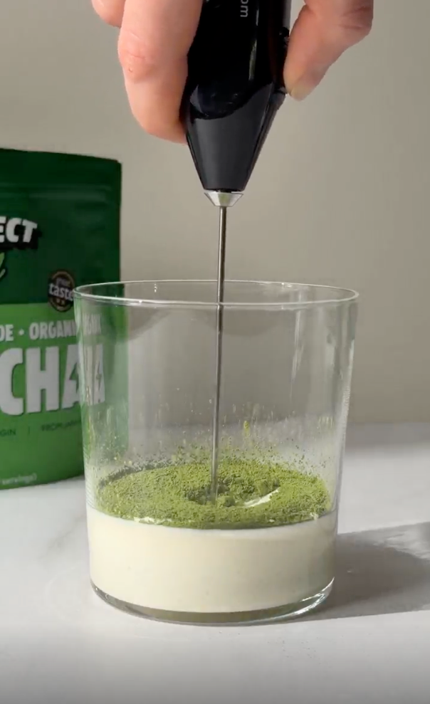 a hand holding a blender